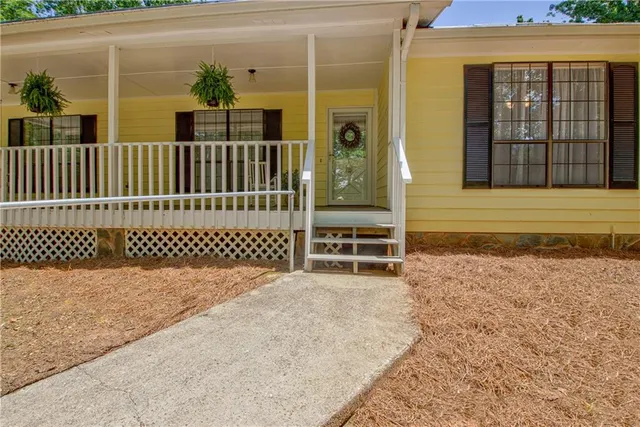 a view of a house with a wooden fence