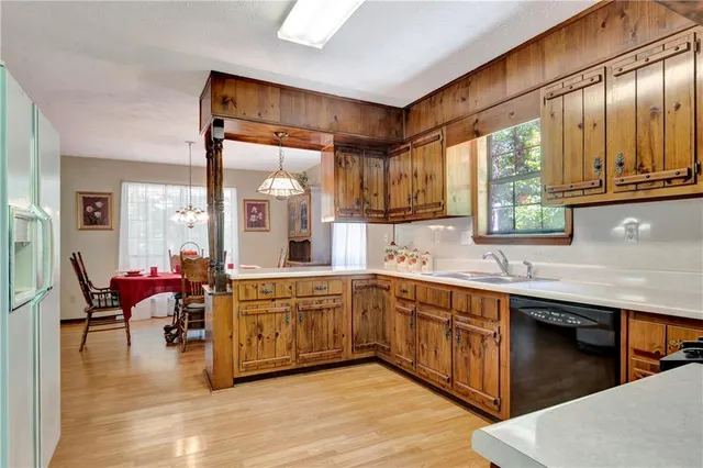 a large kitchen with stainless steel appliances granite countertop a sink and cabinets