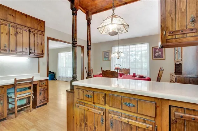 a kitchen with kitchen island granite countertop a sink cabinets and window
