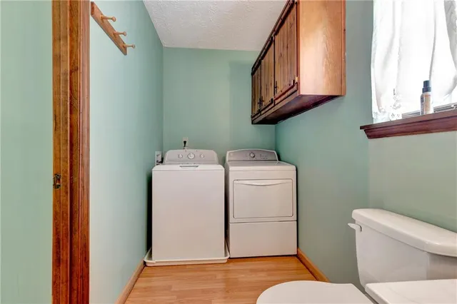 a bathroom with a toilet a sink and a window
