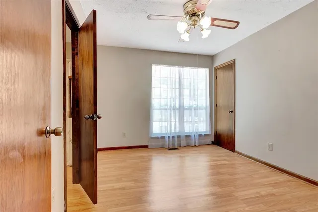 an empty room with windows and entrance