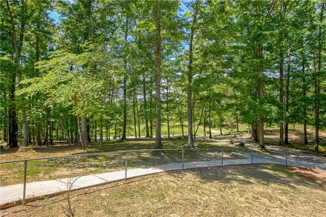 a view of a yard with large trees