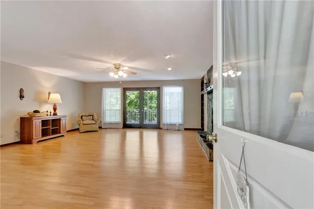 a view of a living room a dining room with furniture and wooden floor