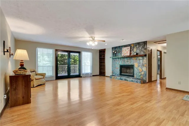 a view of a livingroom with a fireplace and window