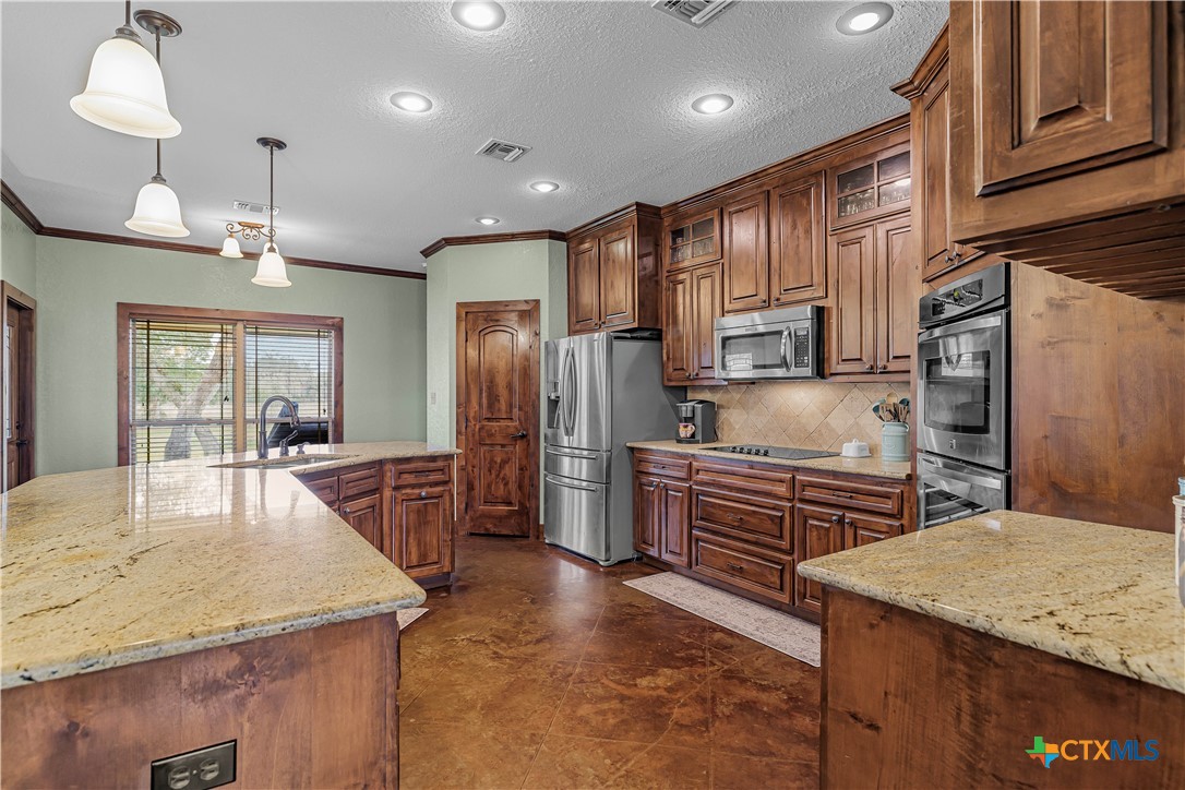 759 Richter Road Inez, TX 77968 - Photo 28 of 48 a kitchen with stainless steel appliances granite countertop a sink refrigerator and cabinets