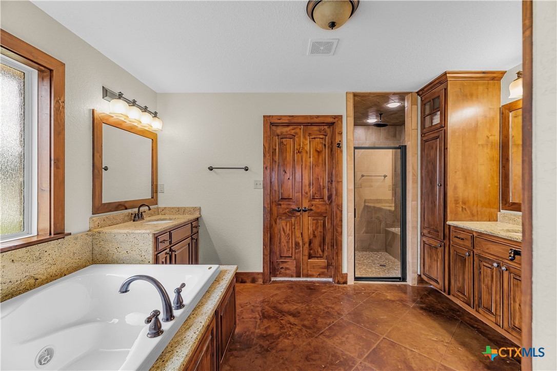 759 Richter Road Inez, TX 77968 - Photo 38 of 48 a bathroom with a tub and a sink
