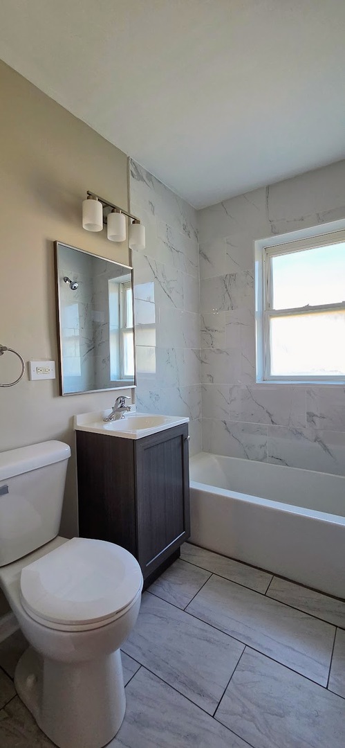 4764 North Virginia Avenue, Unit 206 Chicago, IL 60625 - Photo 12 of 16 a bathroom with a sink a toilet and bathtub