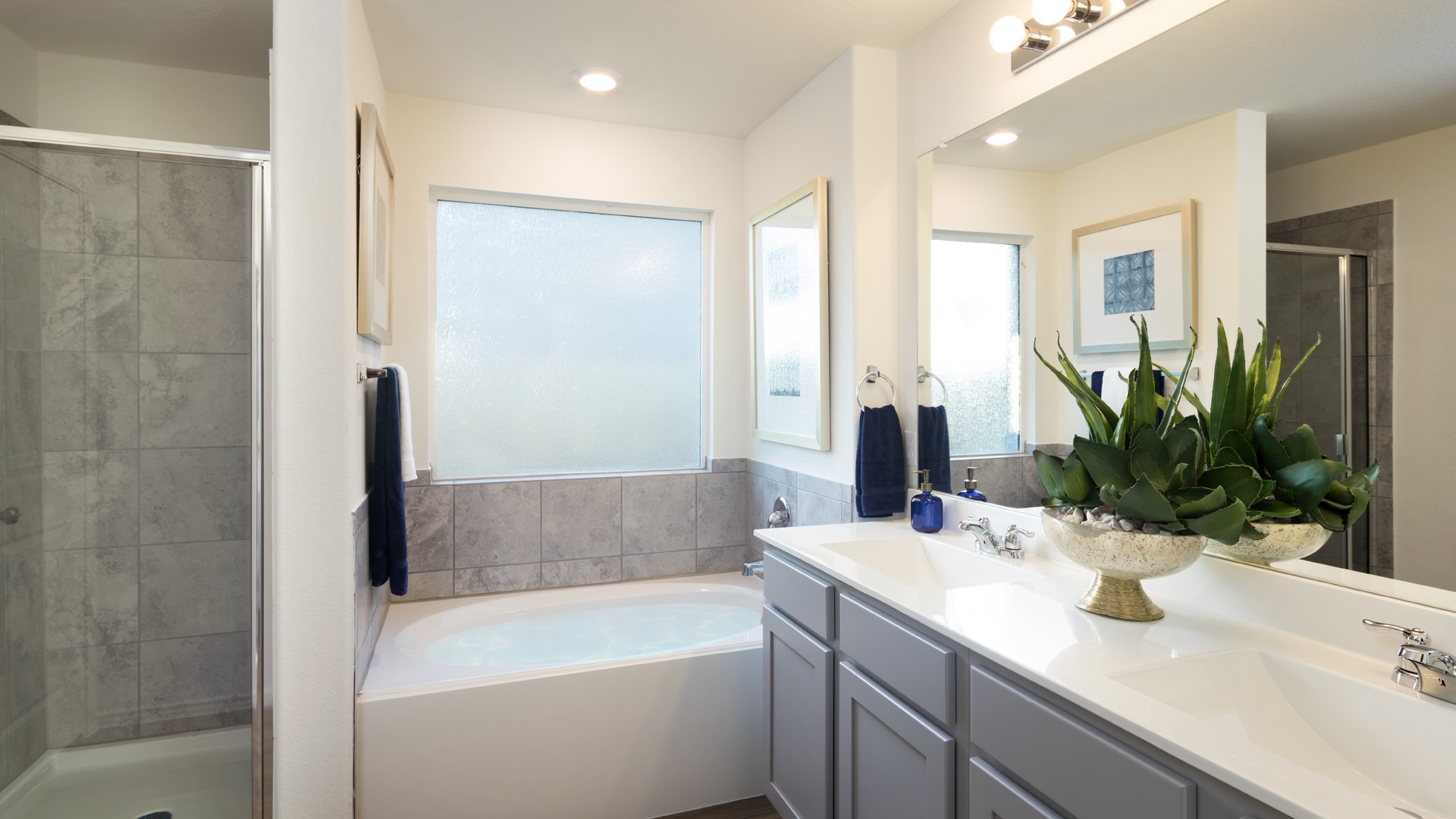 17908 Nashville Warbler Road Pflugerville, TX 78660 - Photo 16 of 19 a bathroom with a tub sink and mirror