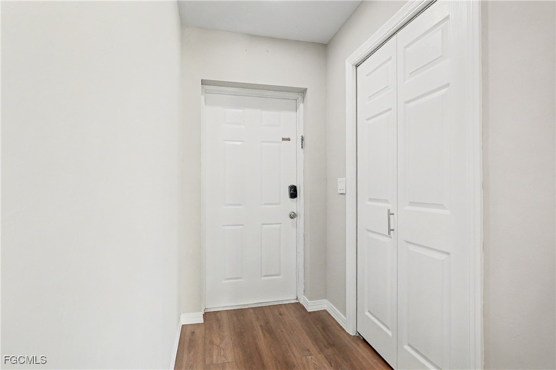 1416 Southwest 50th Street, Unit 63 Cape Coral, FL 33914 - Photo 11 of 23 a view of a hallway with wooden floor
