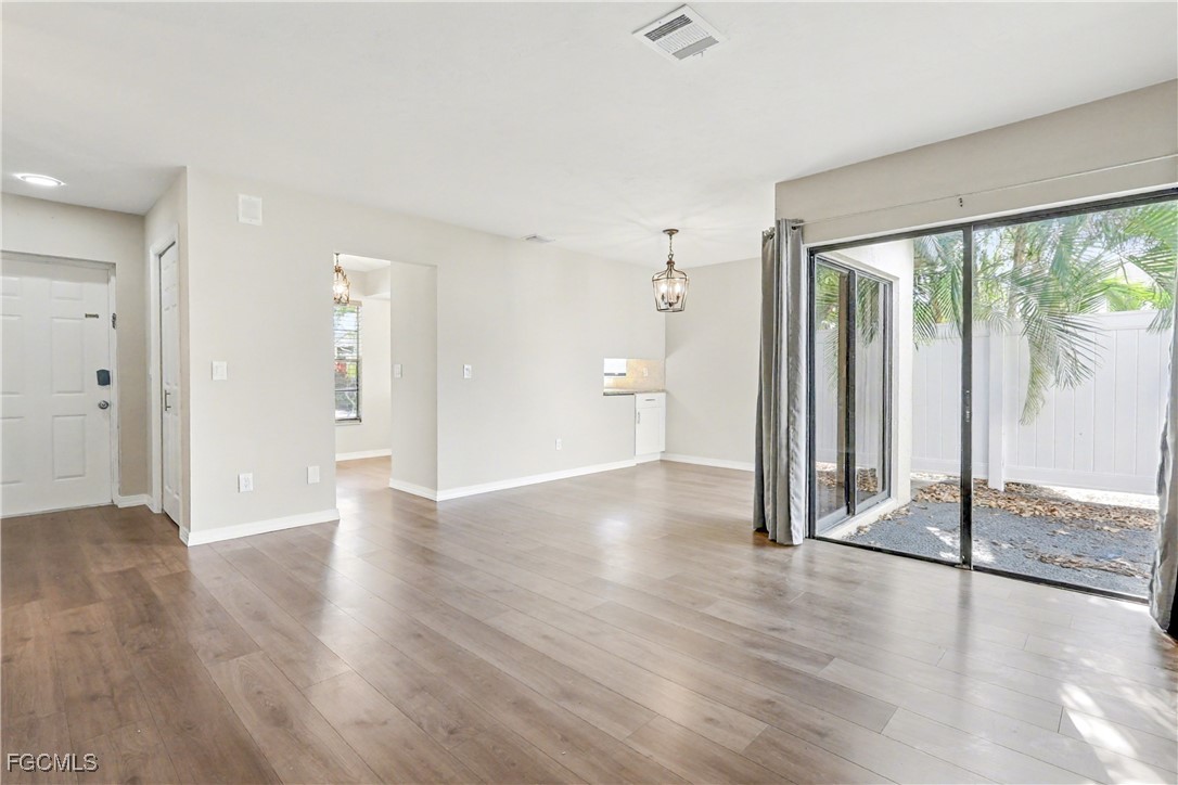 1416 Southwest 50th Street, Unit 63 Cape Coral, FL 33914 - Photo 14 of 23 a view of a room with wooden floor and window