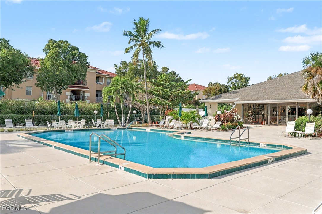 1416 Southwest 50th Street, Unit 63 Cape Coral, FL 33914 - Photo 2 of 23 a view of a swimming pool with a patio