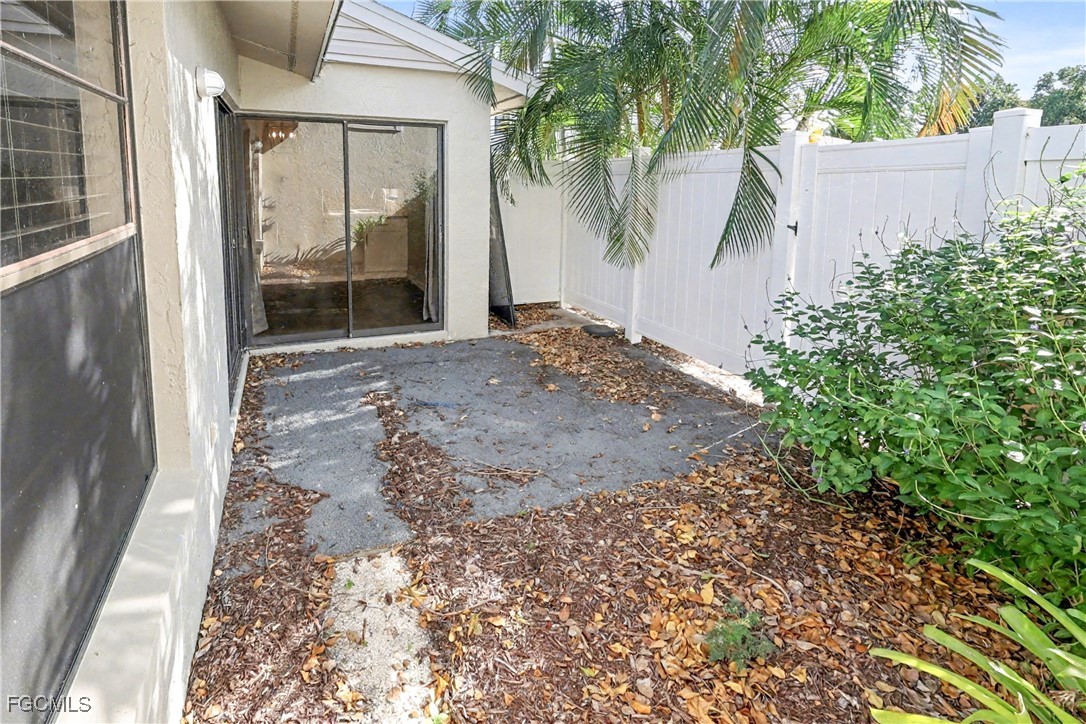 1416 Southwest 50th Street, Unit 63 Cape Coral, FL 33914 - Photo 23 of 23 a view of a backyard with a large tree