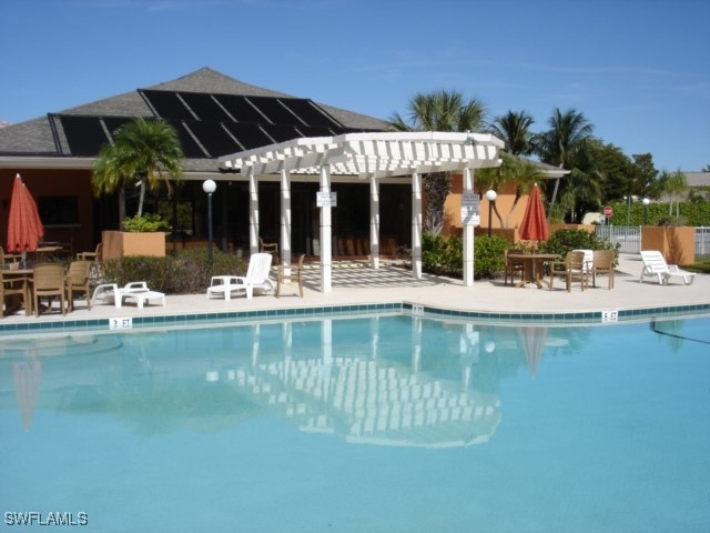 1416 Southwest 50th Street, Unit 63 Cape Coral, FL 33914 - Photo 3 of 23 a view of a house with a swimming pool and sitting area