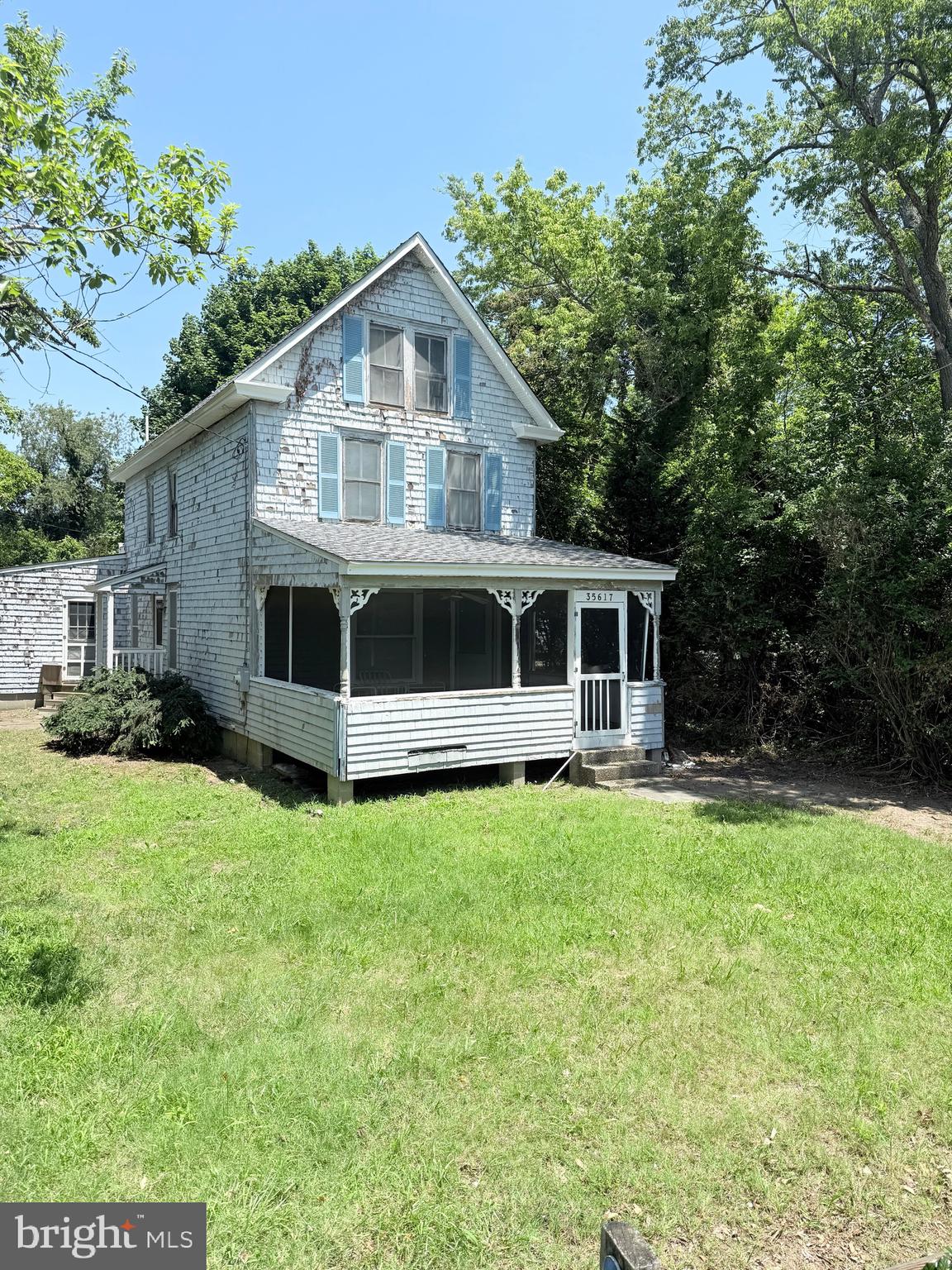 a front view of a house with yard porch and green space