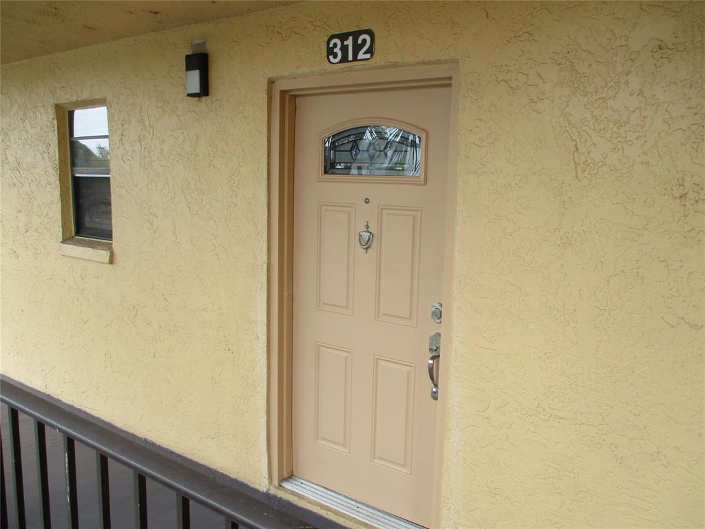 9370 Southwest 8th Street, Unit 312 312 Boca Raton, FL 33428 - Photo 12 of 41 a view of a hallway with wooden floor