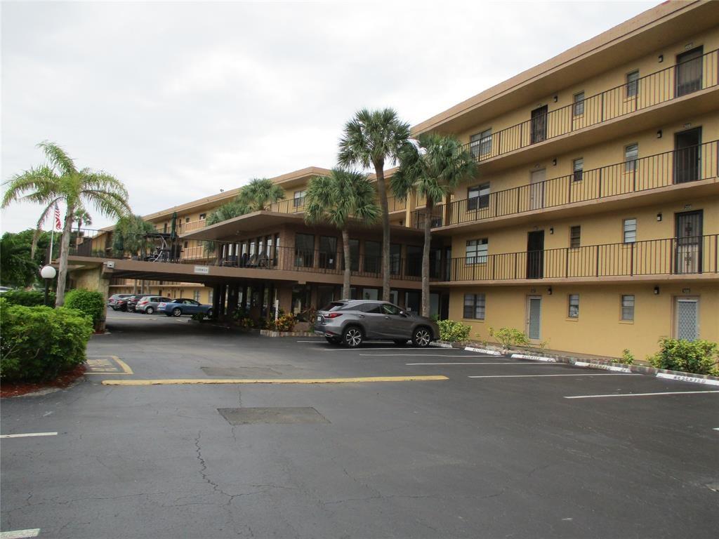 9370 Southwest 8th Street, Unit 312 312 Boca Raton, FL 33428 - Photo 2 of 41 a building with trees in front of it