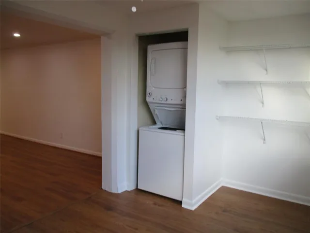 a view of storage and utility room with wooden floor