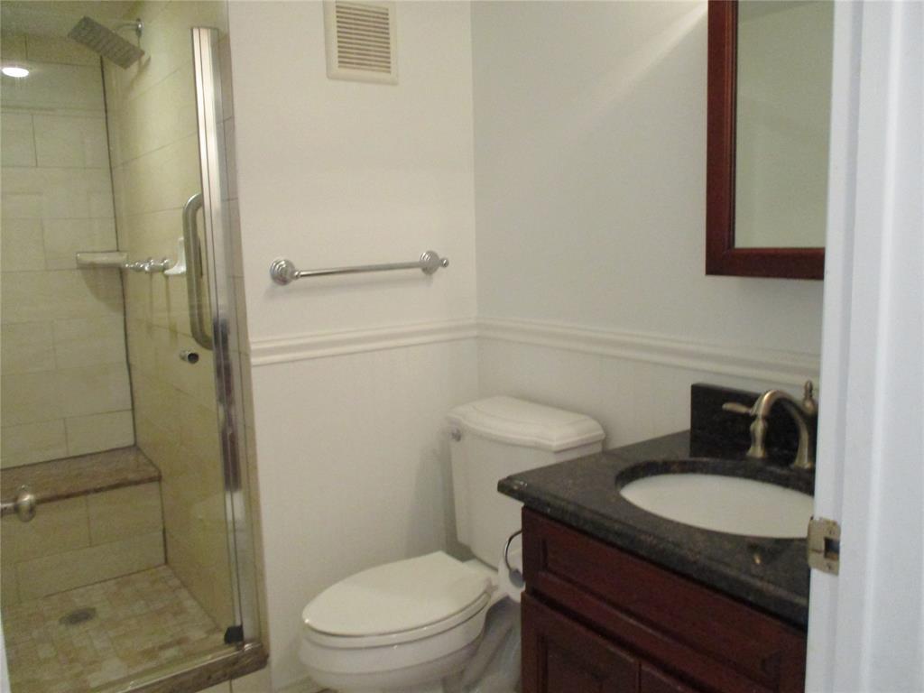 9370 Southwest 8th Street, Unit 312 312 Boca Raton, FL 33428 - Photo 25 of 41 a bathroom with a granite countertop toilet sink and shower
