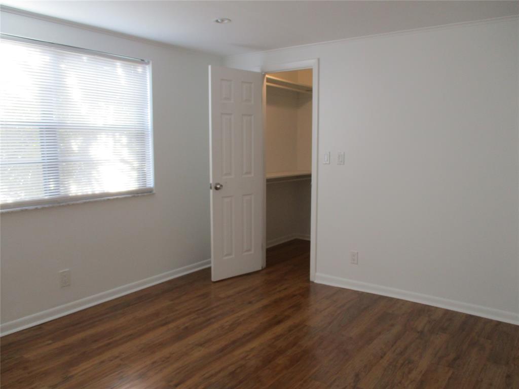 9370 Southwest 8th Street, Unit 312 312 Boca Raton, FL 33428 - Photo 26 of 41 an empty room with wooden floor and windows