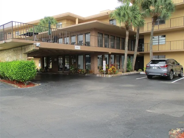 a front view of a house with swimming pool and glass windows