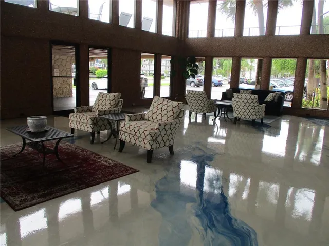 a living room with lots of furniture and a large window