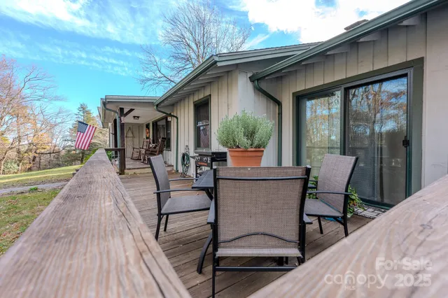 a view of a patio with table and chairs near a garden
