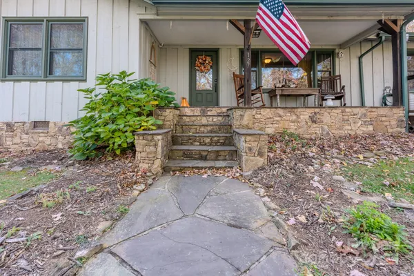 a living room with furniture and stairs