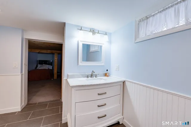 a bathroom with a sink a vanity and a mirror