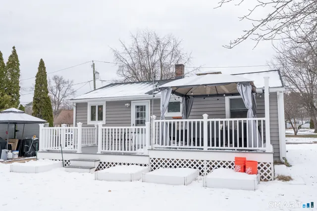 a view of a chairs and table in the balcony