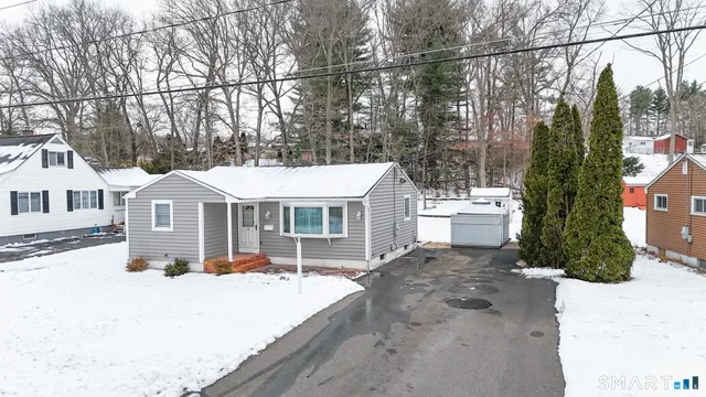 a view of a house with a yard covered in snow