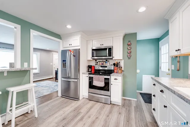 a kitchen with a refrigerator and window