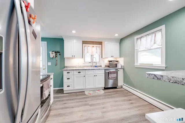 a living room with granite countertop furniture and a wooden floor