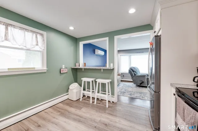a kitchen with stainless steel appliances granite countertop a stove a sink and white cabinets