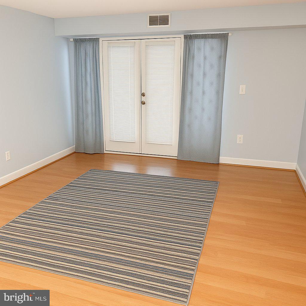 5909 Prince James Drive, Unit D Springfield, VA 22152 - Photo 3 of 18 a view of an empty room with wooden floor