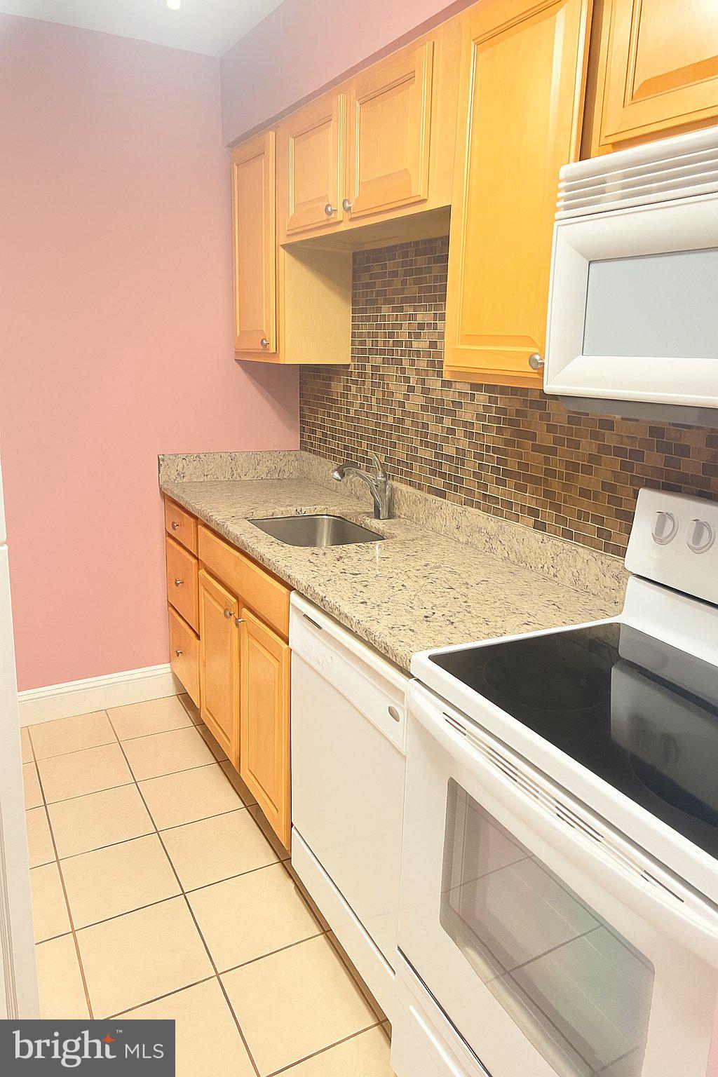 5909 Prince James Drive, Unit D Springfield, VA 22152 - Photo 7 of 18 a kitchen with a sink cabinets and utility