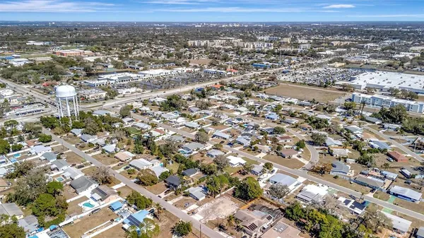 an aerial view of residential houses with city view