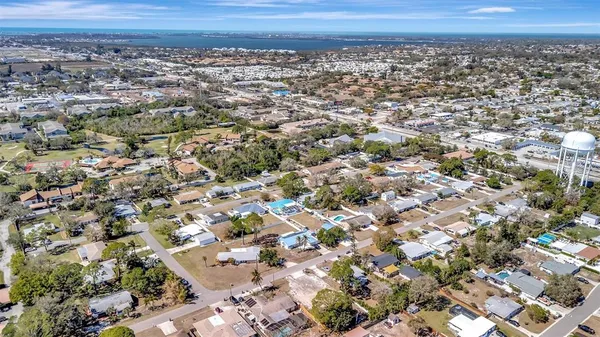 an aerial view of a residential houses with a yard