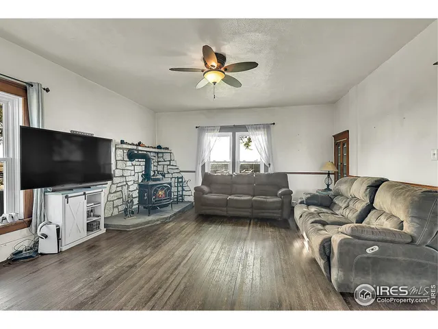 a kitchen with granite countertop a stove top oven a sink dishwasher and a refrigerator