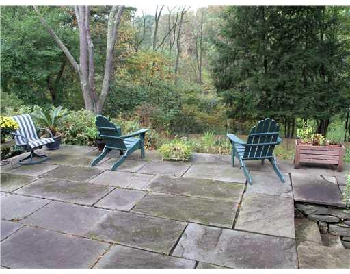 825 Old Mill Road Fox Chapel, PA 15238 - Photo 14 of 17 Patio/Deck. The stone patio is perfect for outdoor dining and relaxation. The distant view is flanked by a nature easement, ensuring no future development.