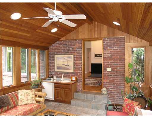 825 Old Mill Road Fox Chapel, PA 15238 - Photo 7 of 17 Sunroom. The sunroom also includes a wet bar and exposed brick wall.