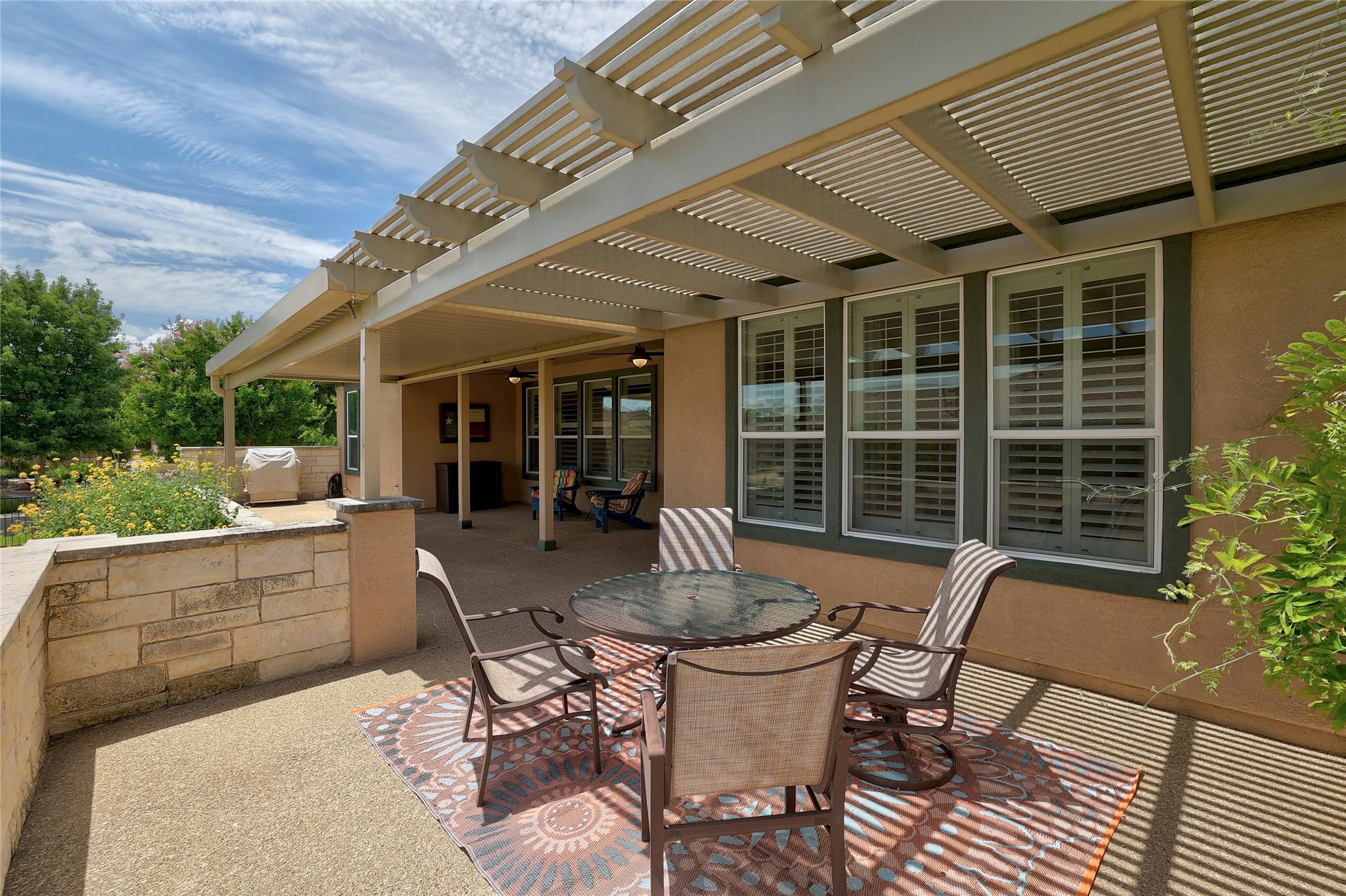 a view of a patio with table and chairs