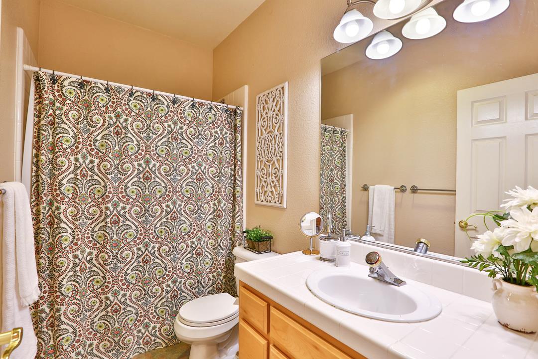 5769 Chambertin Drive San Jose, CA 95118 - Photo 7 of 8 a bathroom with a sink toilet and shower