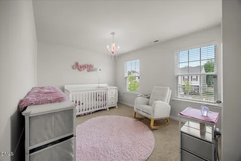 a bedroom with a bed and a flat tv screen on a dresser