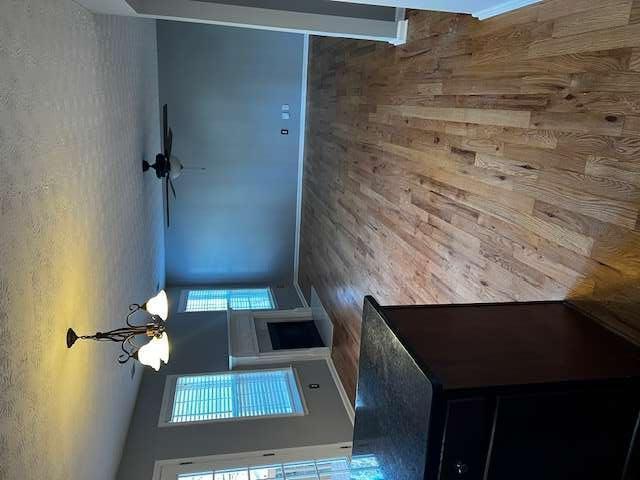 3721 Bogan Mill Road Northeast Buford, GA 30519 - Photo 16 of 41 an empty room with wooden floor fireplace and chandelier