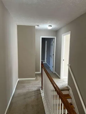 a view of a hallway view with staircase