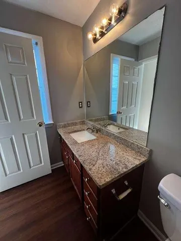 a bathroom with a sink a vanity and a mirror