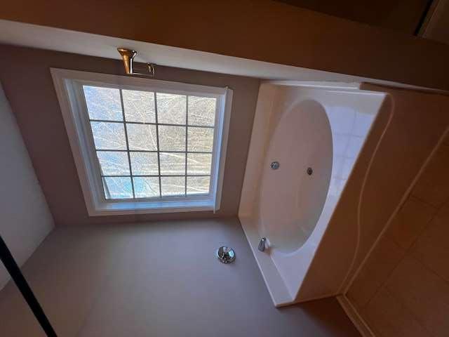 3721 Bogan Mill Road Northeast Buford, GA 30519 - Photo 30 of 41 a bath tub sitting in a bathroom next to a window