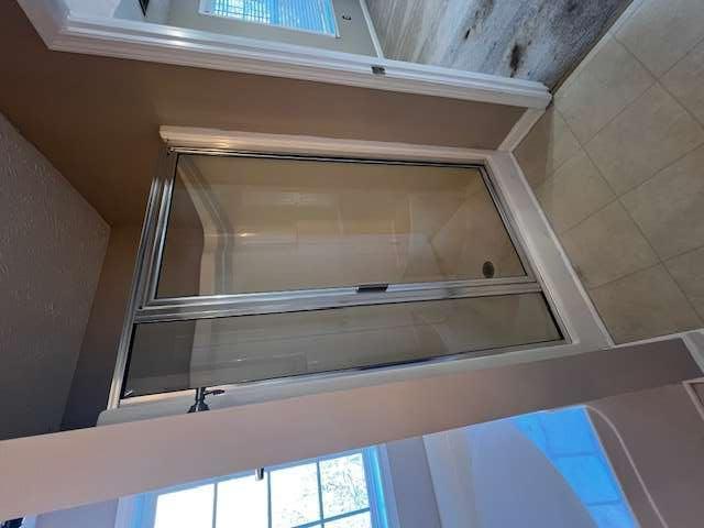 3721 Bogan Mill Road Northeast Buford, GA 30519 - Photo 32 of 41 a bathroom with a glass door shower and closet