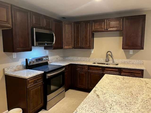 3721 Bogan Mill Road Northeast Buford, GA 30519 - Photo 35 of 41 a kitchen with a sink and a stove top oven
