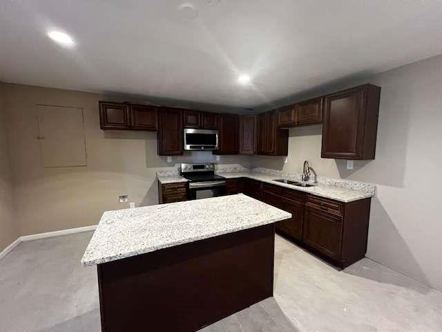 3721 Bogan Mill Road Northeast Buford, GA 30519 - Photo 36 of 41 a kitchen with kitchen island granite countertop wooden cabinets a refrigerator and a sink
